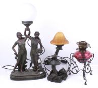 A cranberry oil lamp and two electric lamps.