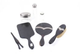 A collection of dressing table items including a silver mounted ebonised round hand mirror and