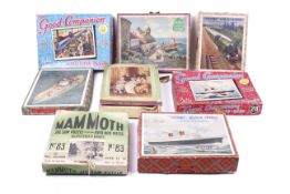 An assortment of vintage jigsaw puzzles. Including a Victory 'Queen Elizabeth' puzzle, Mammoth No.