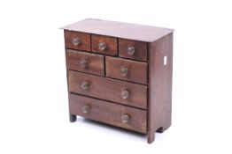 A miniature chest of drawers.
