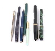 Seven vintage pens and pencils.