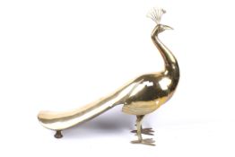 A substantial brass model of a peacock.