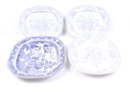 Four blue and white glazed platters.