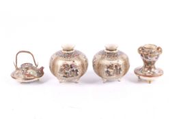 A pair of miniature Meiji period Japanese Satsuma vases and a miniature teapot.
