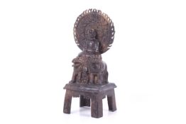 A Tibetan bronze figure of the Buddha Amitabha seated on a pair of lions.