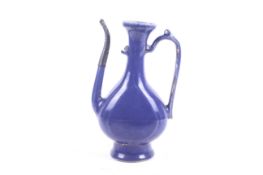 A Chinese 16th century monochrome blue glazed ewer.