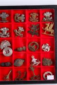 A collection of Welsh military badges and a belt buckle.
