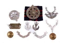 A small group of Scottish military badges and buttons.