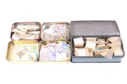 A collection of world stamps in five tins.