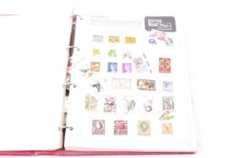 A worldwide collection of stamps in red Stanley Gibbons Worldex folder.