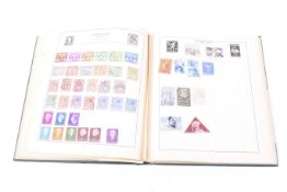 A worldwide collection of stamps in a Strand album from 1950.