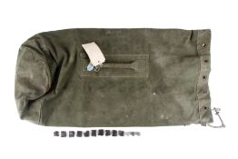 A 1953 British National Service army kit bag, musket balls and flints. The bag marked for H.W.