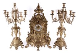 A 20th Century German rococo style brass mantel clock garniture.