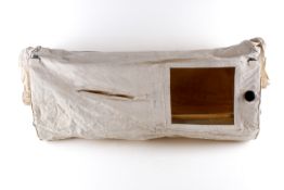 A German WWII baby gas crib. The fabric cover with plastic window, around a wooden frame.