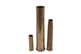 Three WWII military shell cases.