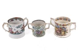 Three twin handled cider mugs.