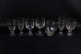 A collection of seven assorted glass items. Consisting of six drinking glasses and a jug. Max.