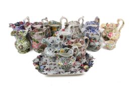 A collection of Victorian and later ceramic jugs and a serving plate.