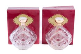 Two Lalique Le Baiser glass perfume bottles.
