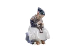 A Royal Copenhagen figure of a woman sewing. No.1314, H15.
