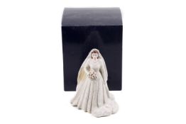 A Royal Worcester figure of Elizabeth II in her wedding dress.