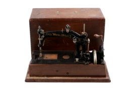 A Wheeler & Wilson No.8 hand crank sewing machine. In a wooden case, L46.
