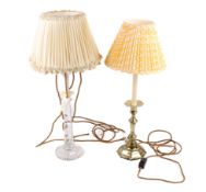 Two table lamps. Comprising a brass example modelled as a candlestick and a glass example. Max.