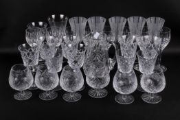 A large collection of cut glass drinking glasses. Including brandy, wine and some champagne flutes.