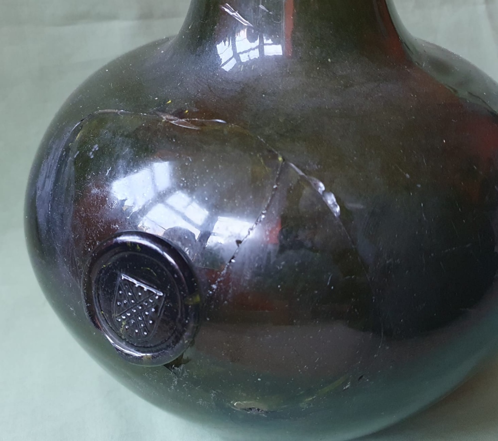 A very large onion shaped 17thC glass bottle with heraldic seal, circa 1690 - the section around the - Image 3 of 5