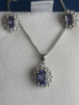 A small modern tanzanite & diamond cluster pendant in 9ct white gold on chain together with a pair