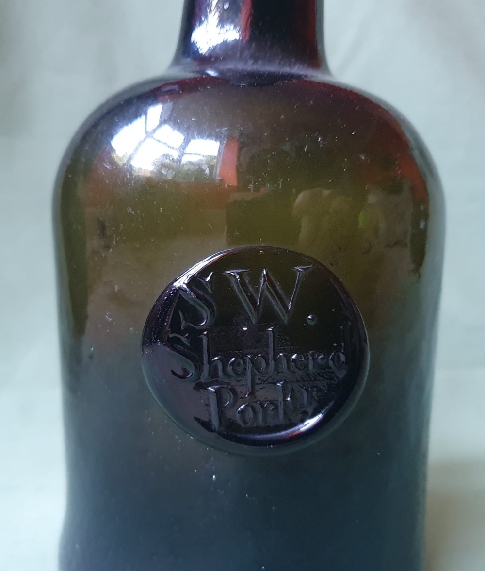 An 18thC sealed glass bottle - S.W. Shepherd Portr - small bruise to body, 9.25" high. - Image 2 of 4