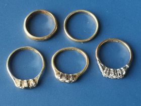 Three small diamond set rings and two gold wedding rings. (5)