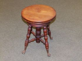 A Canadian adjustable revolving circular music stool on glass ball & metal claw feet by Thomas Organ