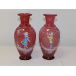 A pair of 'Mary Gregory' cranberry glass vases with coloured enamel decoration, one depicting a