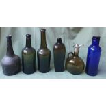 A collection of antique glass bottles, the tallest 11".