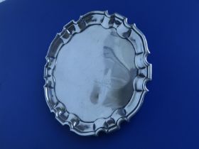 A George II silver waiter with piecrust edge on three pad feet - 'GEA', John Tuite, London 1740,