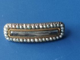 A Victorian pearl set rectangular yellow metal mourning brooch, 1.25".