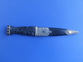 A silver mounted skean dhu, having Celtic knot decoration to hilt & sheath, citrine coloured end-