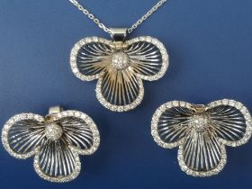 A diamond set white flowerhead pendant necklace with matching earrings, of openwork design, each