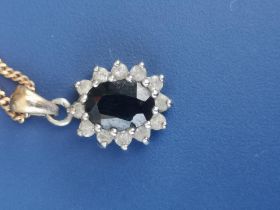 A sapphire & diamond oval white metal cluster pendant on fine link 9ct necklace chain.