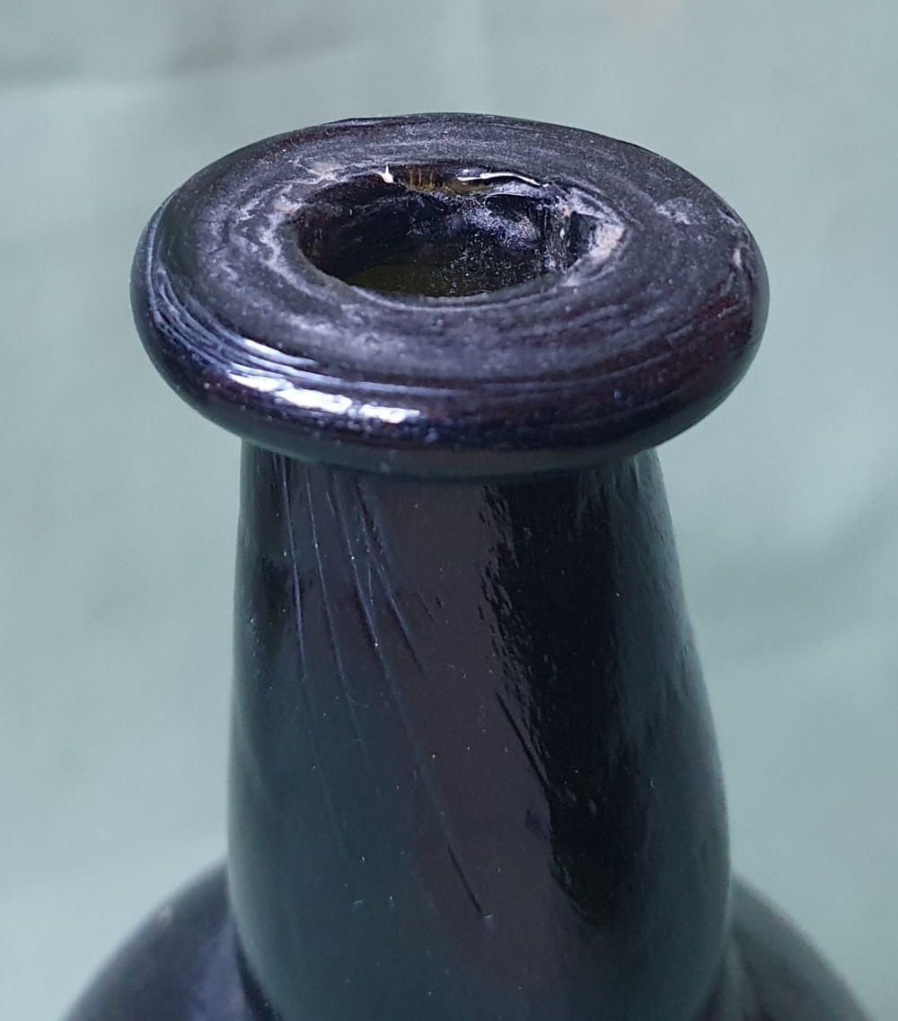 A glass bottle with remains of a paper label - Fortnum Mason, 8" high. - Image 2 of 4