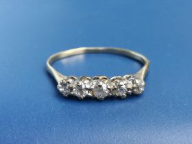 A small five stone graduated diamond ring on (buckled) yellow metal shank. Finger size N.