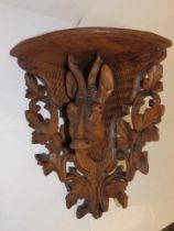 A Black Forest antelope head corner shelf bracket, 15" high.