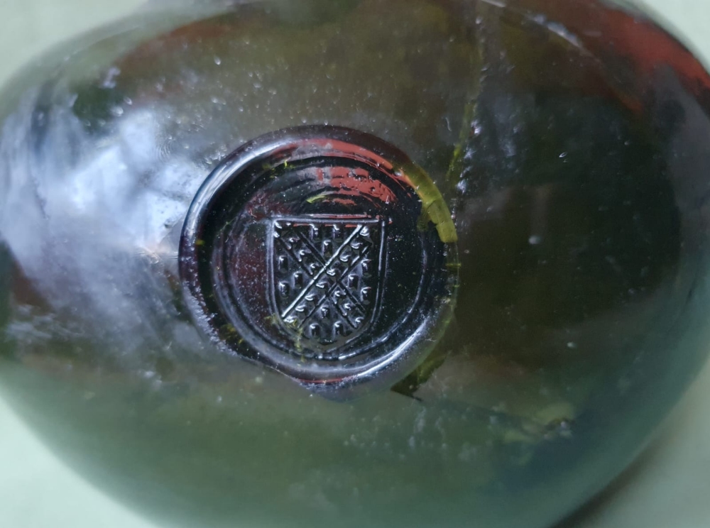 A very large onion shaped 17thC glass bottle with heraldic seal, circa 1690 - the section around the - Image 4 of 5