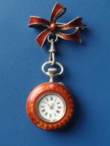 A lady's Swiss orange guilloche enamelled silver fob watch with matching bow, the back with floral