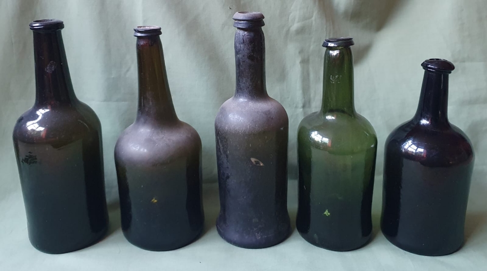 Five antique blown glass bottles, the tallest 11".