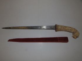 An old hunting knife with carved bone lion-head handle, the 16" steel blade decorated with hunting