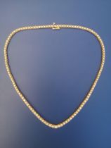 A graduated diamond set line necklace, having 123 claw-set brilliants ranging in diameter from 1.7mm