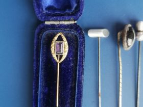An amethyst set 18ct gold stick pin and six others. (7)