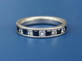 A sapphire & diamond calibre set platinum half eternity ring. Finger size M.